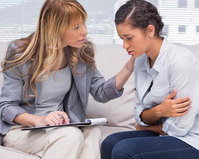 a young female patient having a psychotherapy session with a psychologist